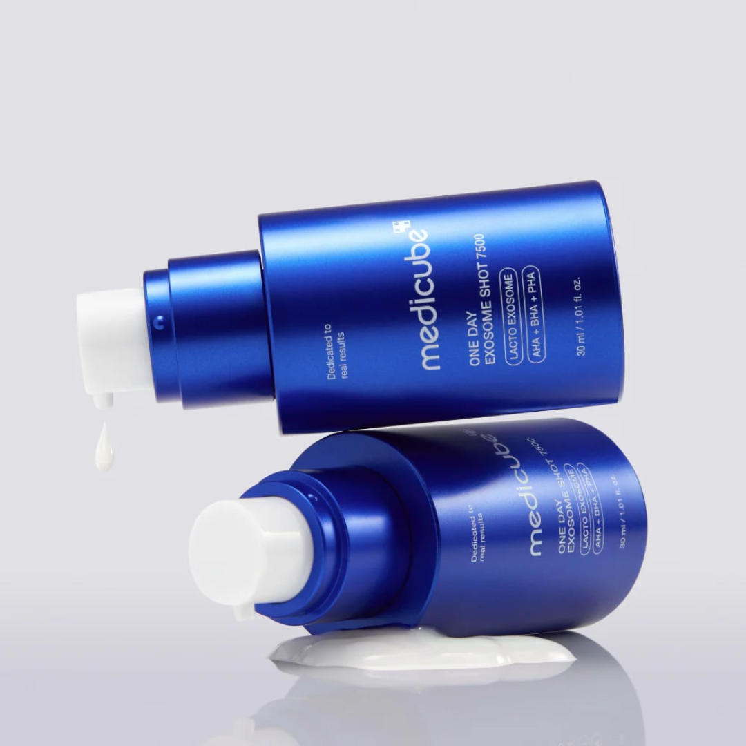 Two blue bottles of Medicube skincare product on a light gray background