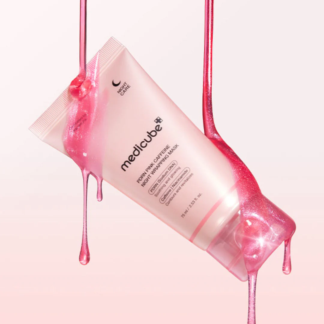Medicube pink cream tube with pink cream oozing out on a pink background