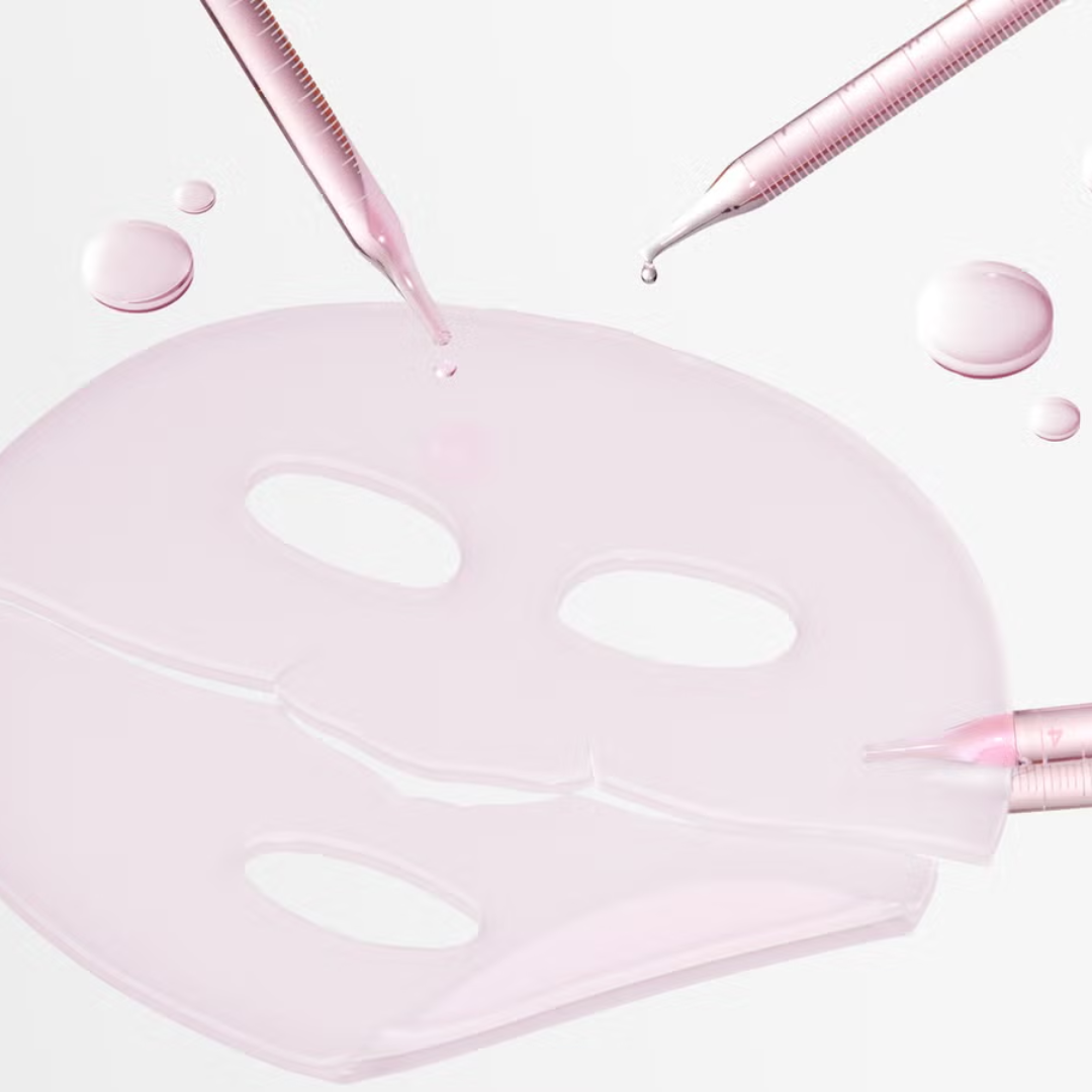 Pink face mask with serum being applied on a white background