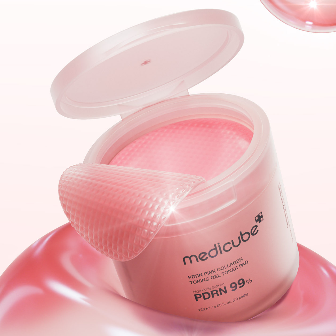 Pink skincare product with a toner pad on a white background
