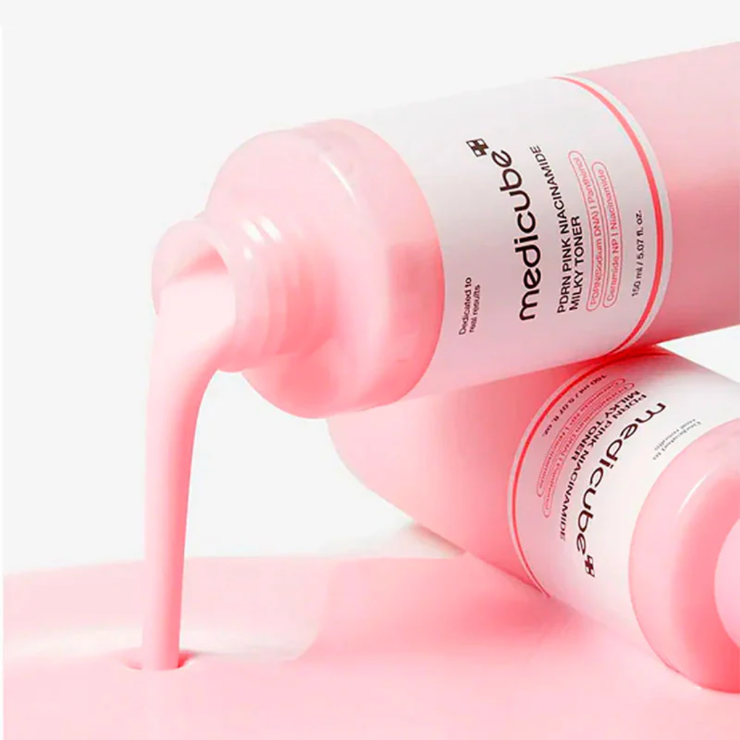 Pink toner bottle with pink liquid being poured out on a white background