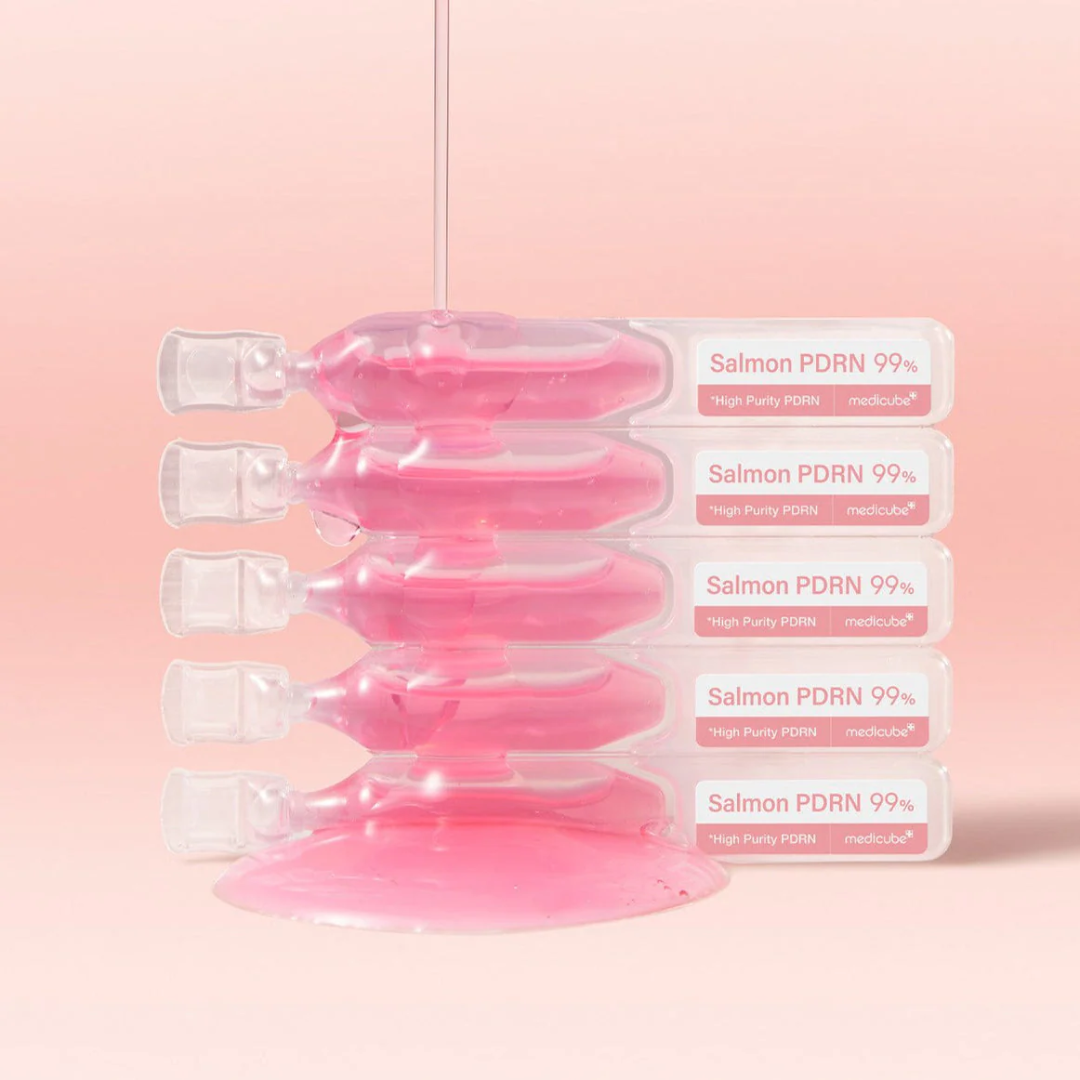 Five pink ampoules with labels on a pink background
