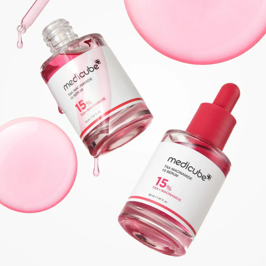 Two bottles of Medicube skincare product with pink serum on a white background