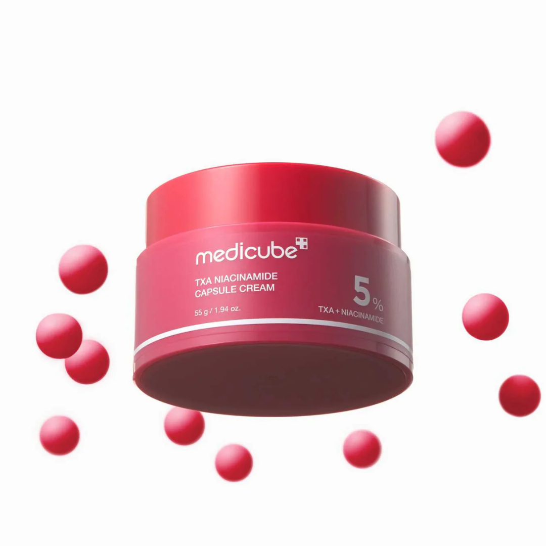Red jar of Medicube cream with scattered red capsules on a white background