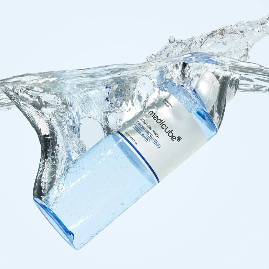 Medicube bottle with water splashes on a light blue background