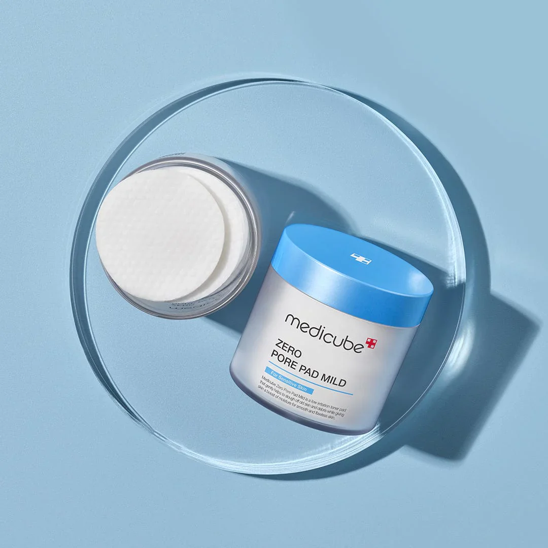 Medicube Zero Pore Pad Mild product on a clear circular stand with a blue background