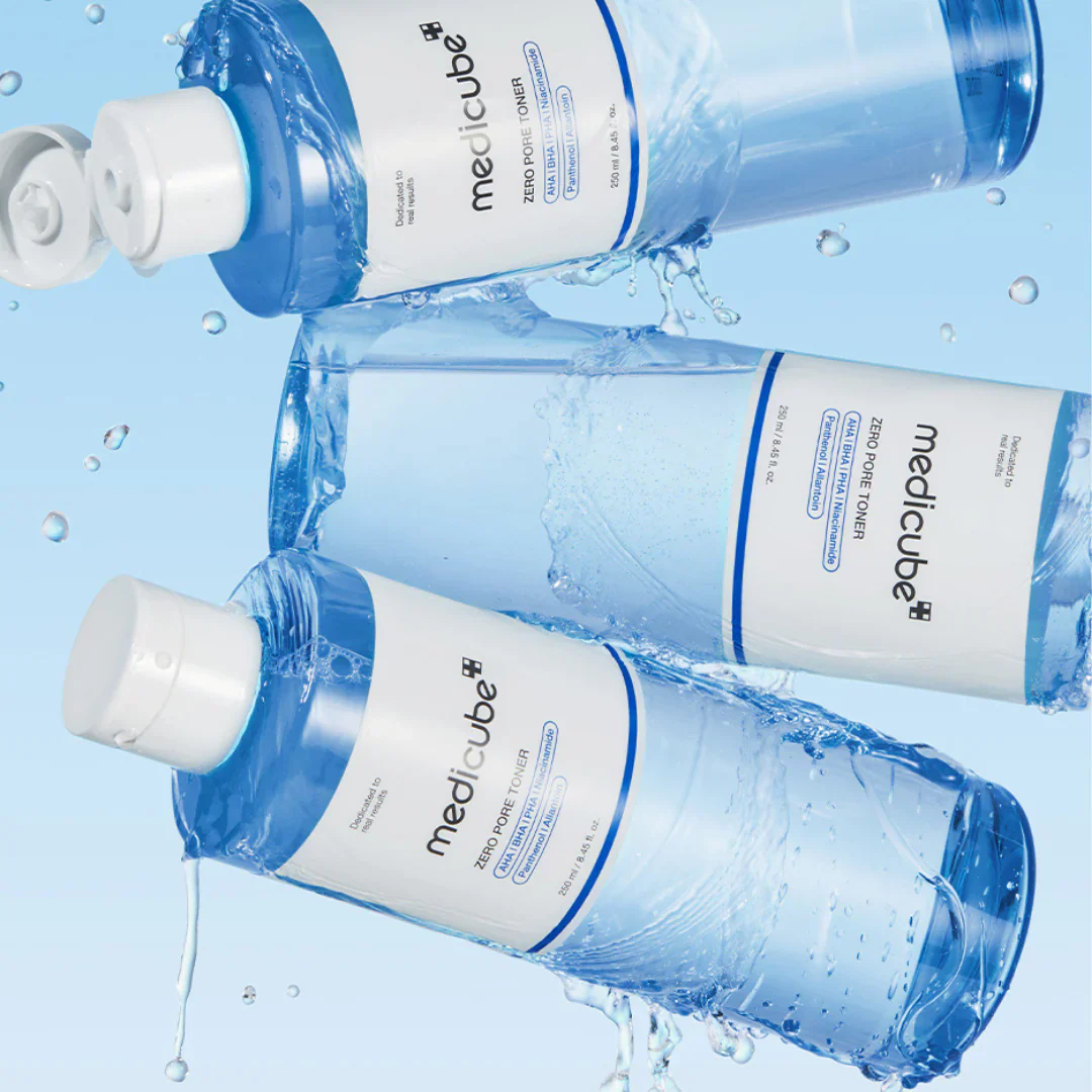 Medicube toner bottles with water droplets on a blue background