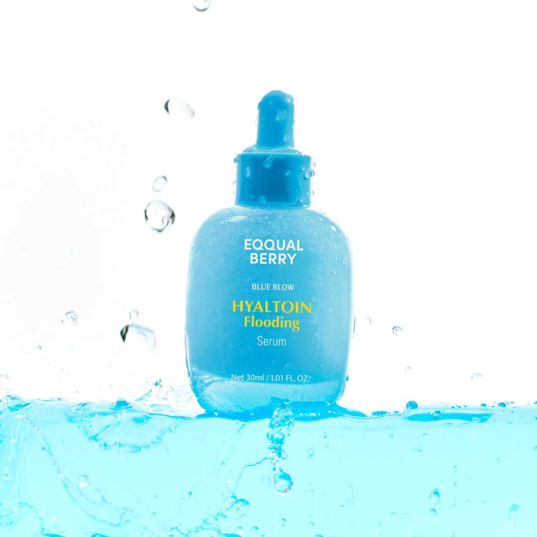 Blue skincare serum bottle with dropper on a water splash background