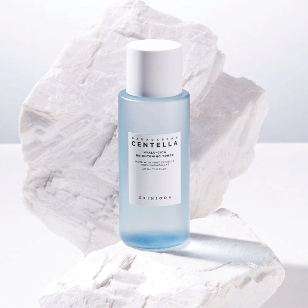 Skincare bottle with a white cap on a textured white background