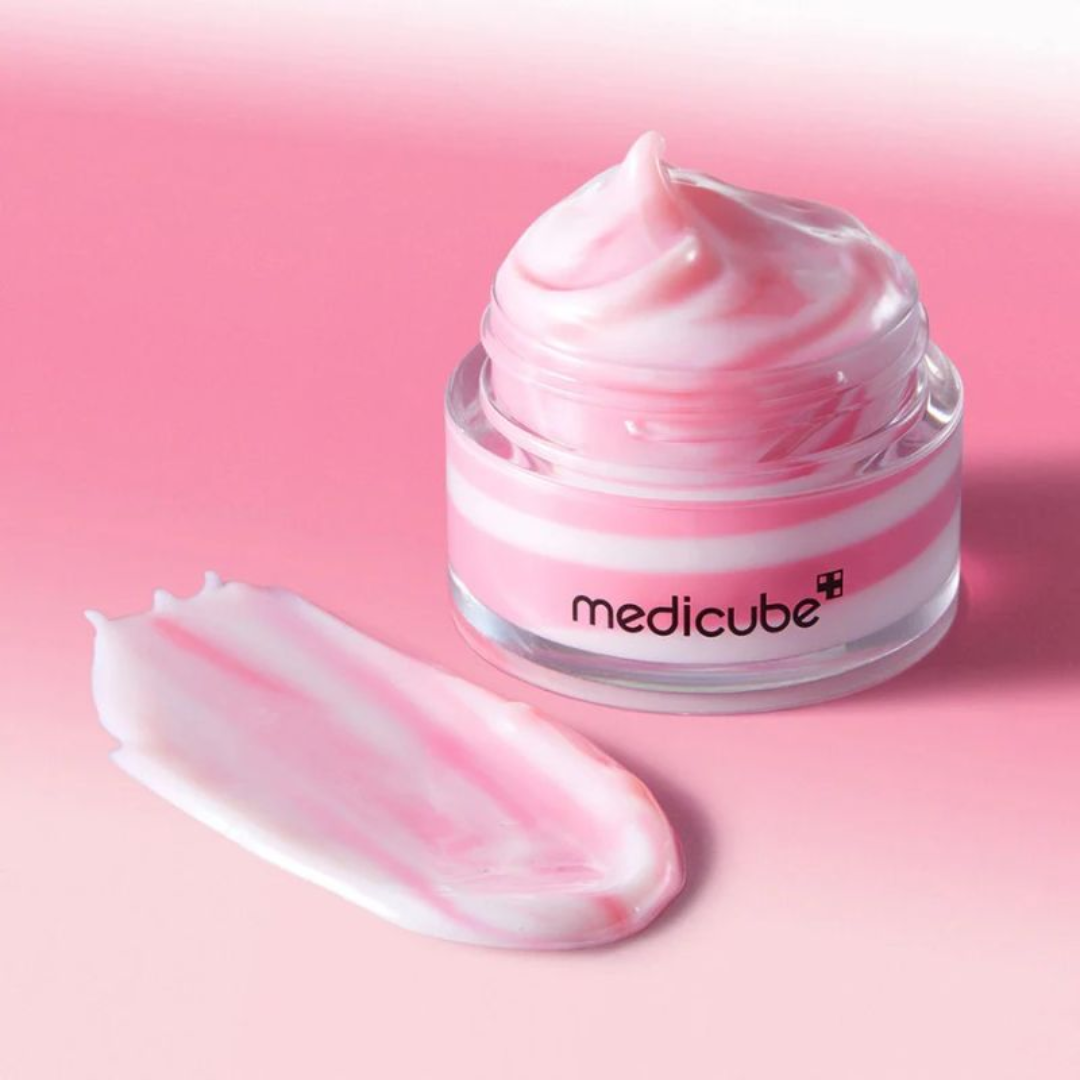 Pink skincare product jar with 'medicube' branding on a pink background