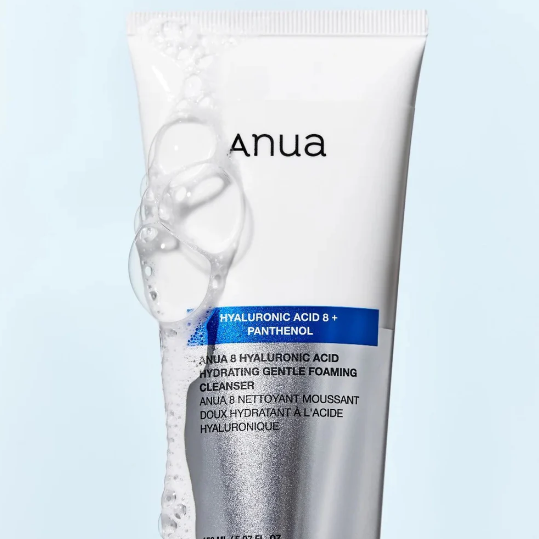 Tube of Anua cleanser with foam on a light blue background