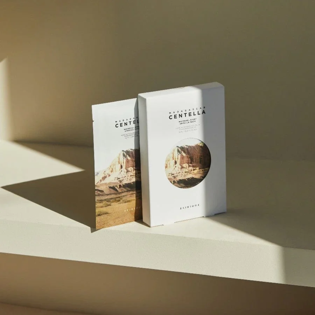Two boxes of Centella on a beige surface with a neutral background