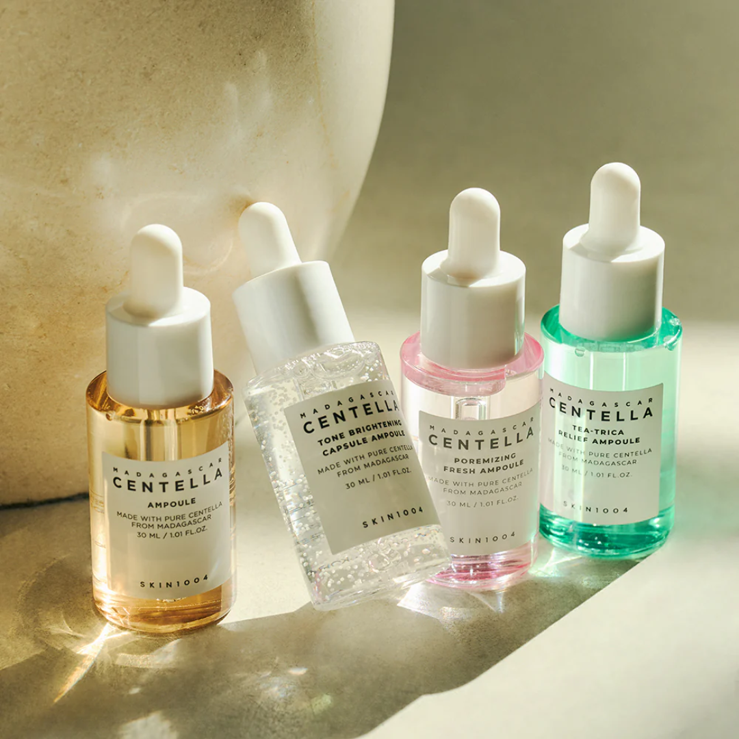 Four Skinfood Centella Ampoule bottles with droppers on a neutral background