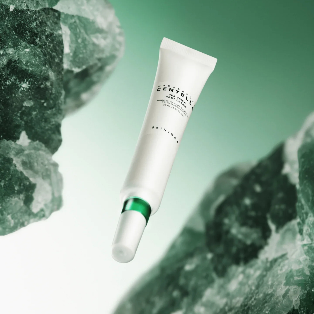 Skincare tube with green gemstones on a light green background