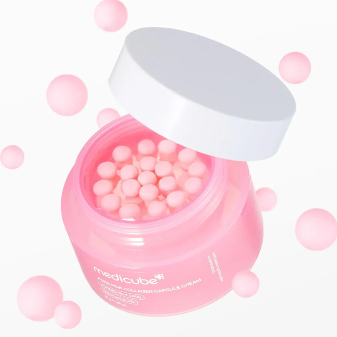 Pink jar of Medicube capsules with a white lid on a light pink background