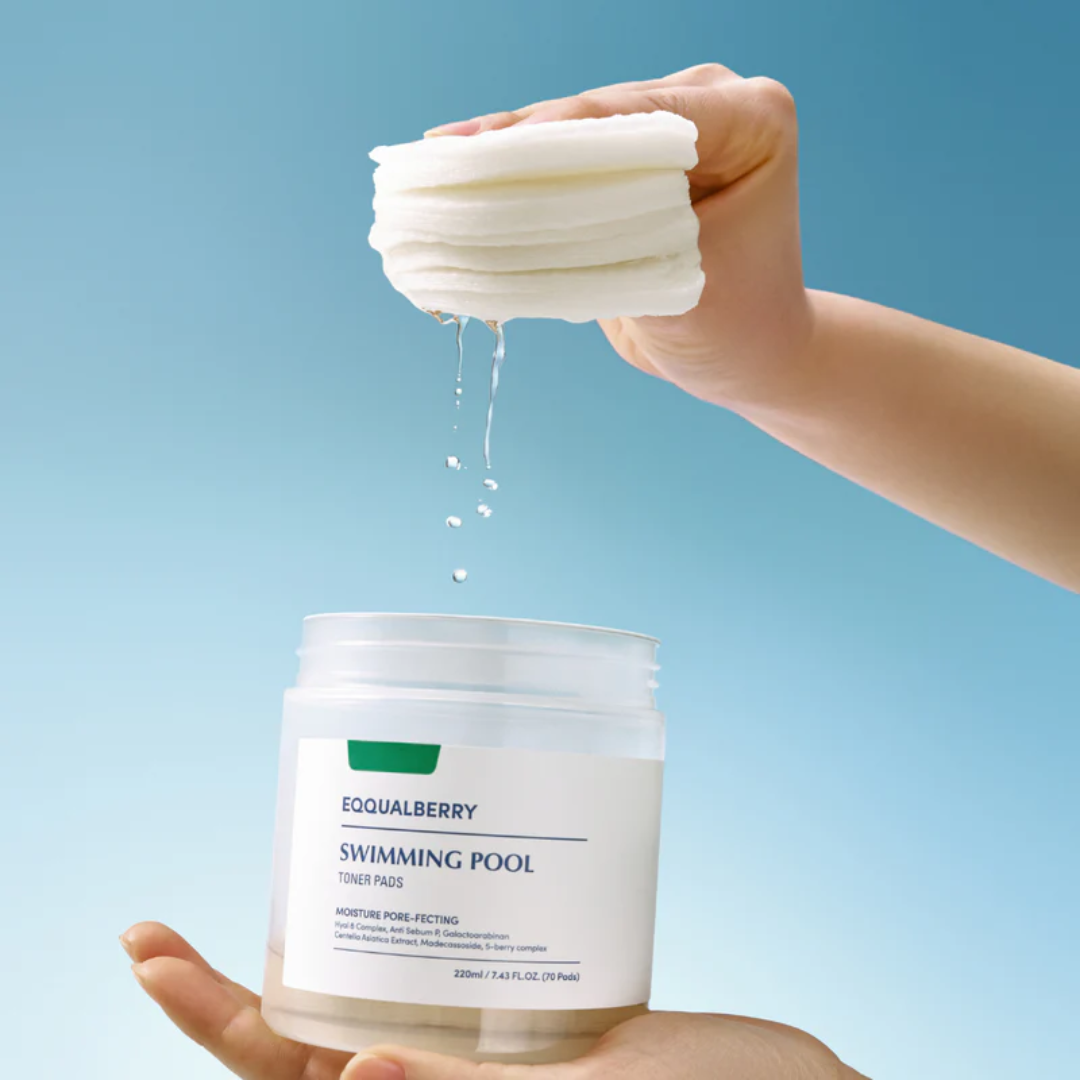 Hand pouring a white liquid from a container labeled 'EQUALEBERRY Swimming Pool' onto another container against a blue background.
