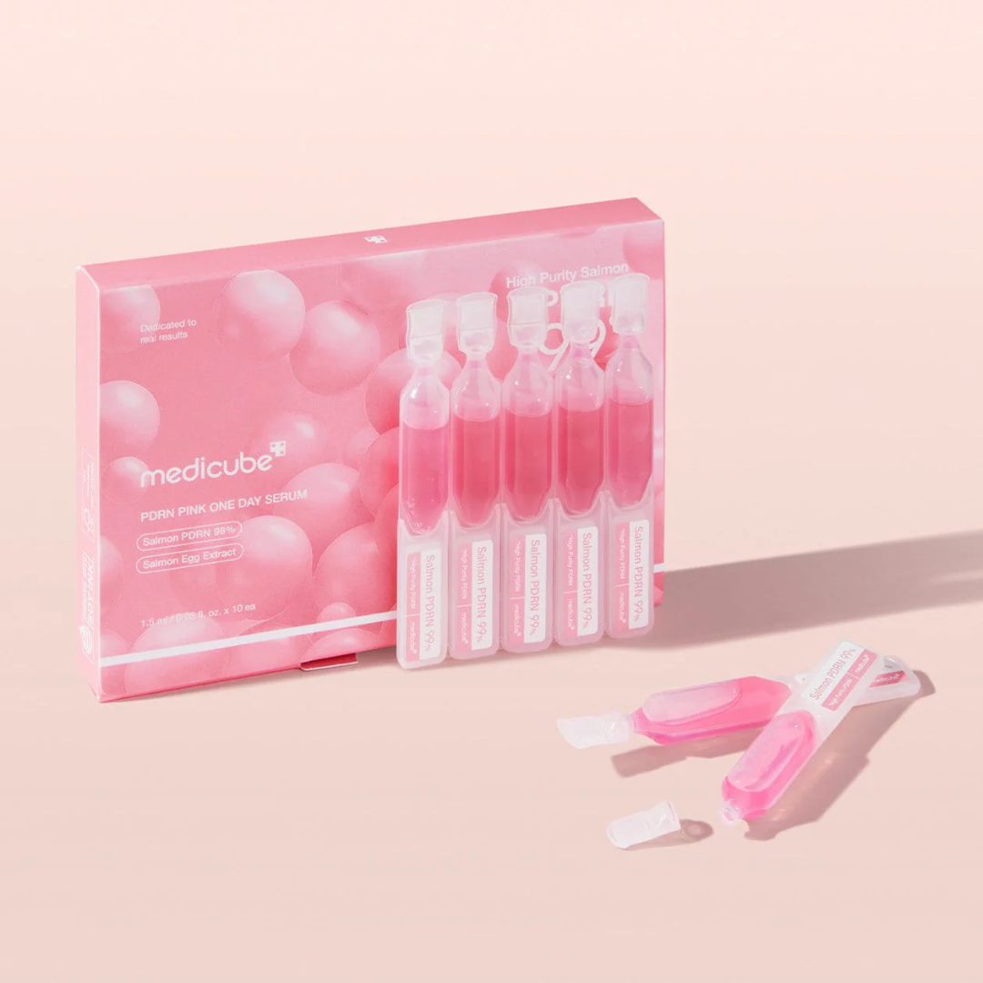 Medicube eye serum set with pink packaging on a light pink background