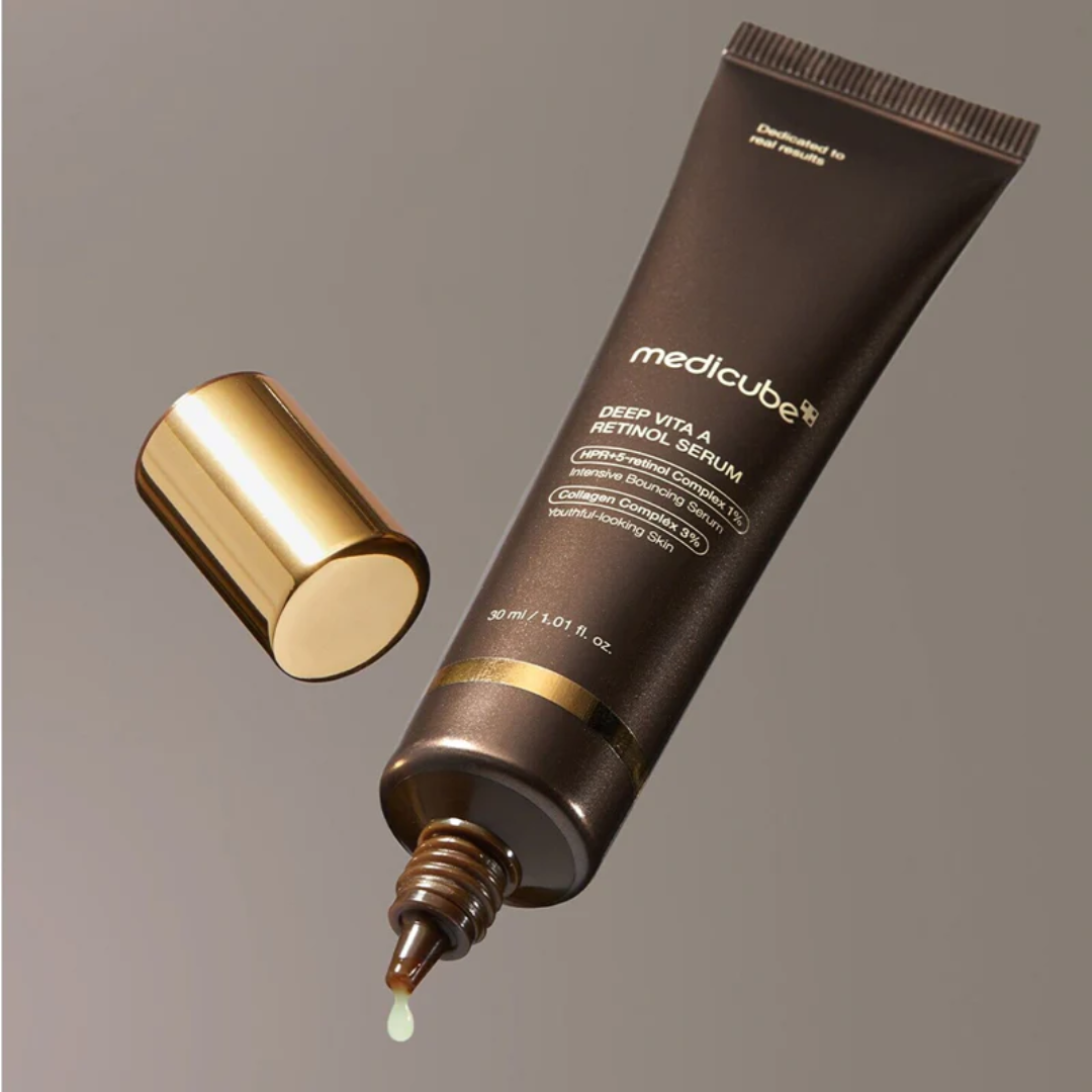 Medicube Deep Vita A Retinol Serum tube with dropper on a gray background