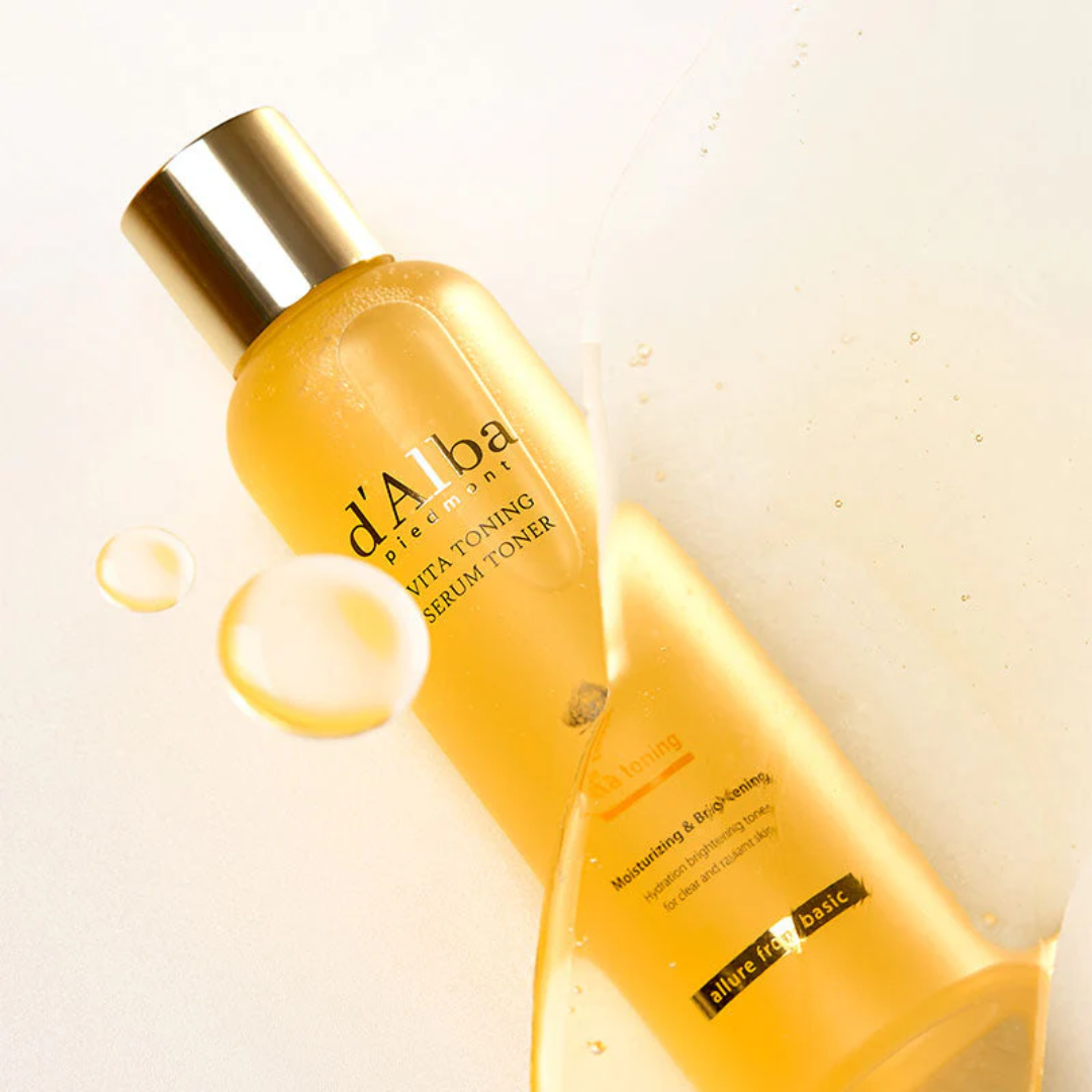Yellow skincare bottle with gold cap on a light beige background