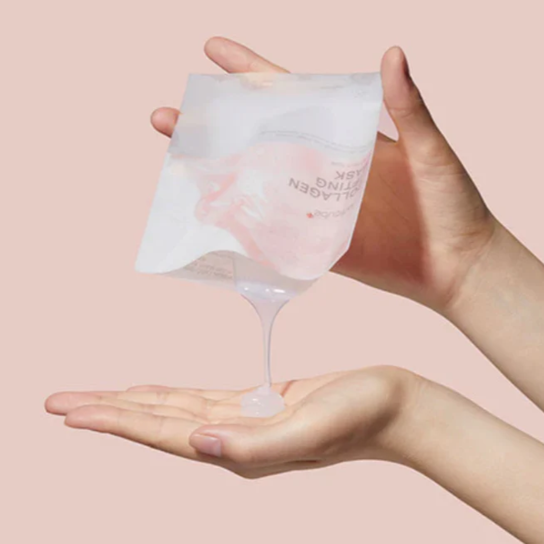 Hand holding a clear silicone mask package with pink liquid against a pink background