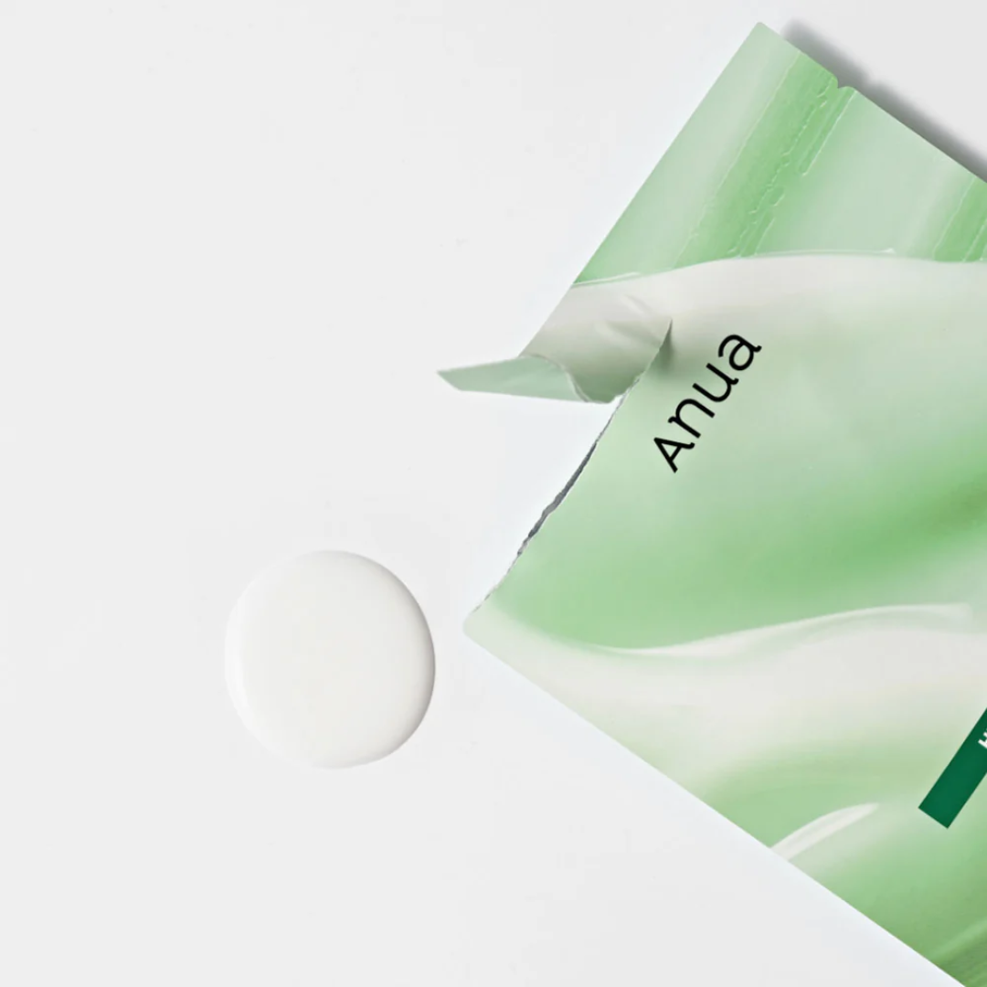 Green skincare mask with 'Anua' branding on a white background