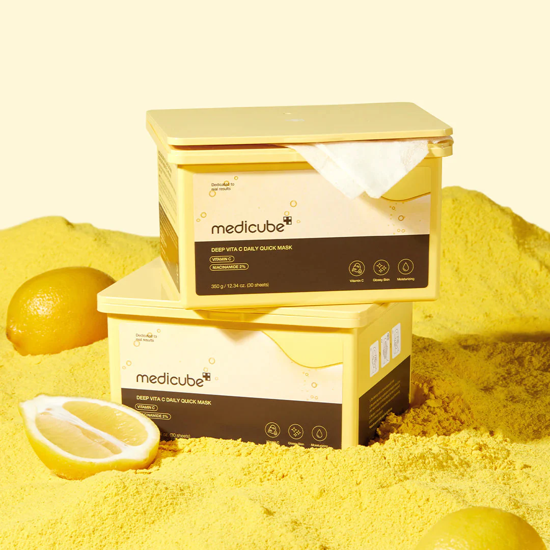 Two boxes of Medicube skincare product on a yellow background with lemons.