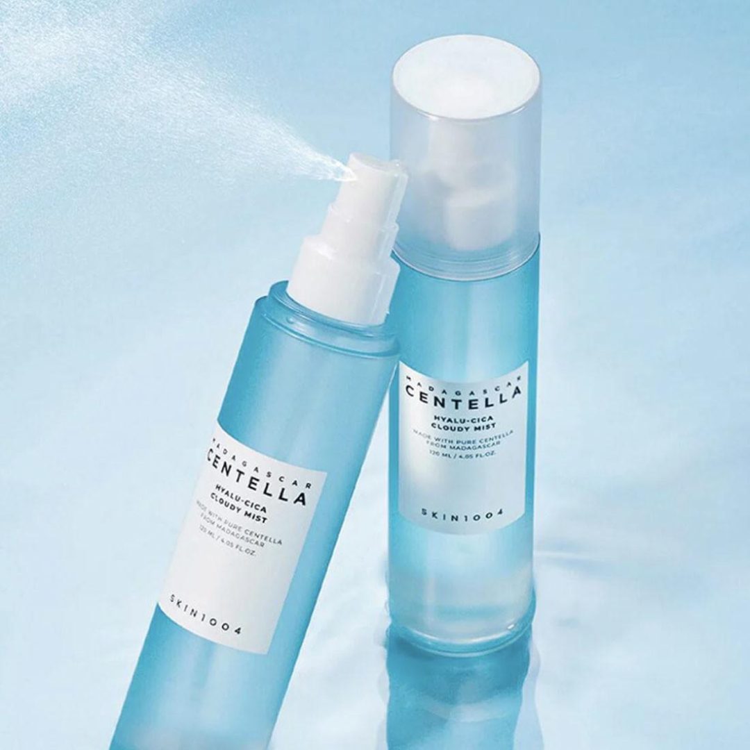 Two bottles of Centella Asiatica water spray on a light blue background