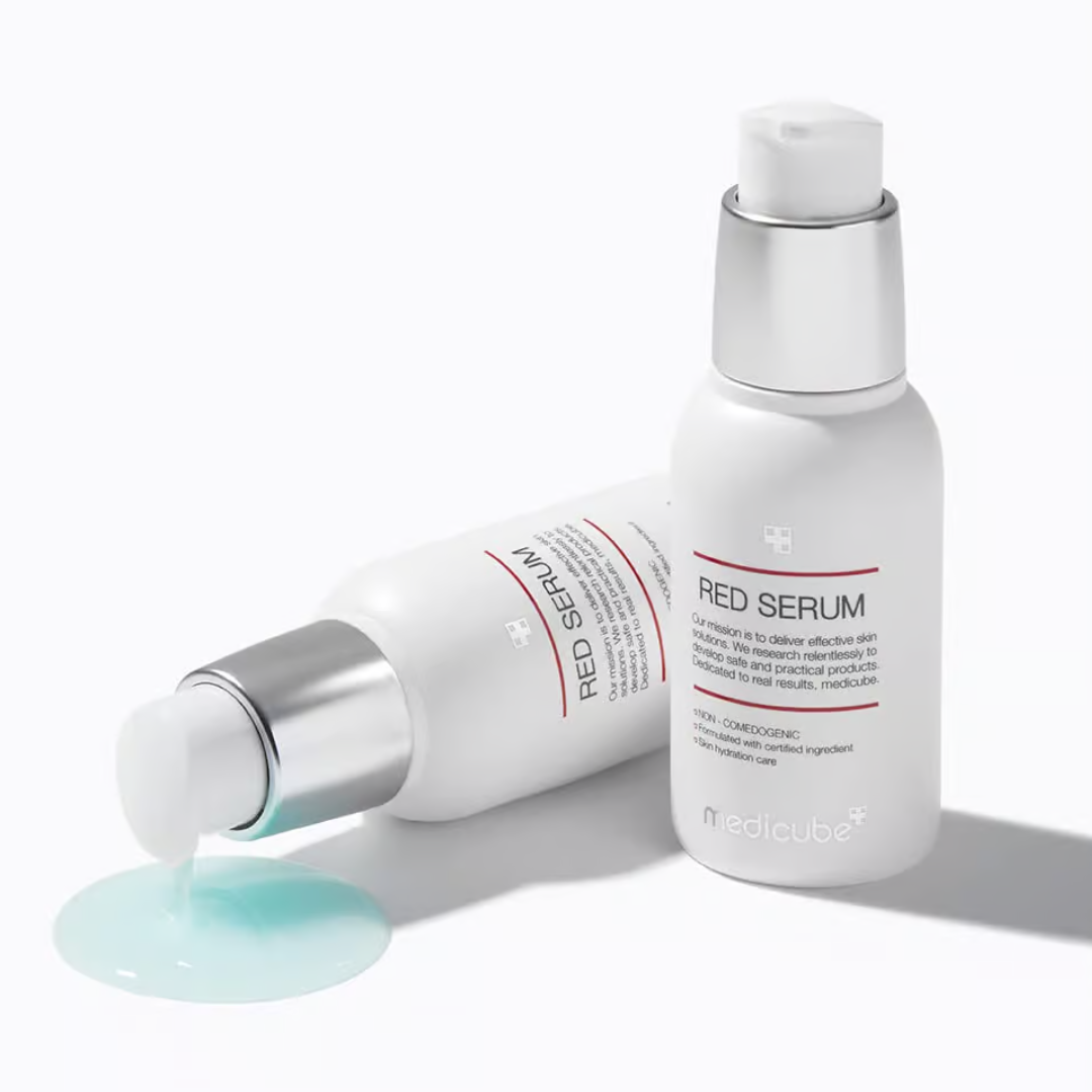 Two bottles of Red Serum with a droplet of serum on a white background