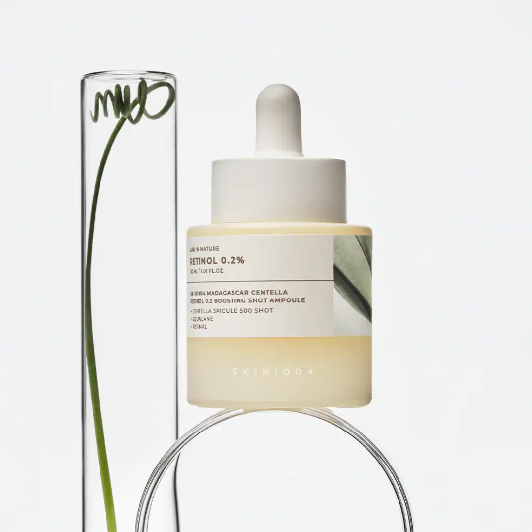 Skincare serum bottle with dropper on a light gray background