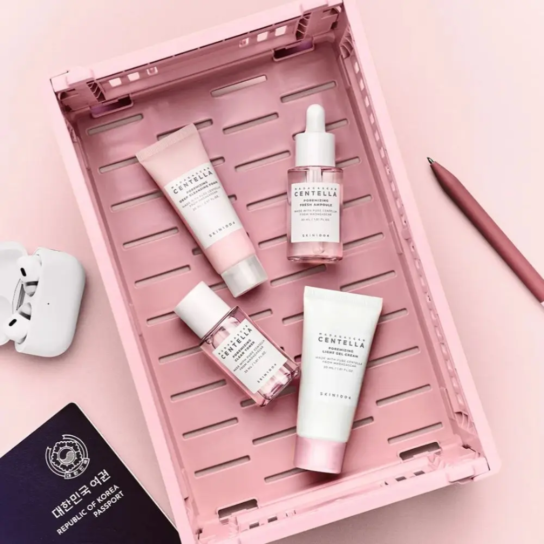Cosmetic products with Centella Asiatica on a pink tray against a pink background