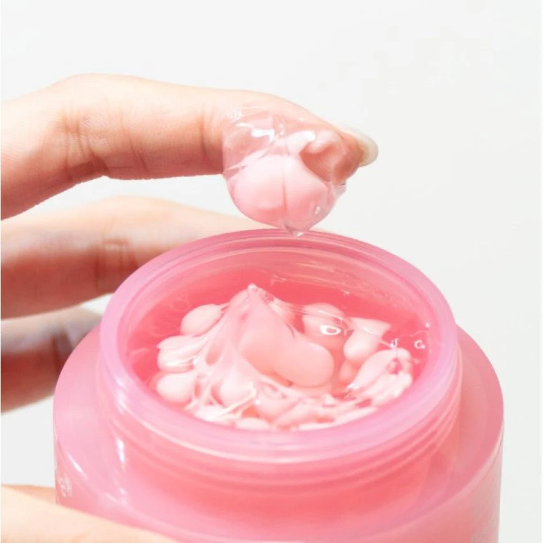 Pink gel being applied with a finger from a container