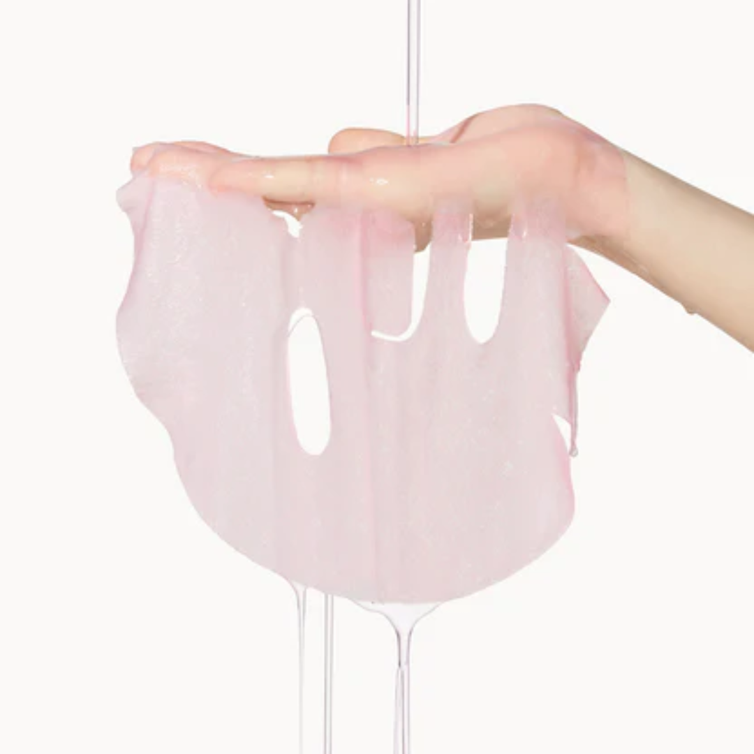 Pink slime stretching between two hands on a white background