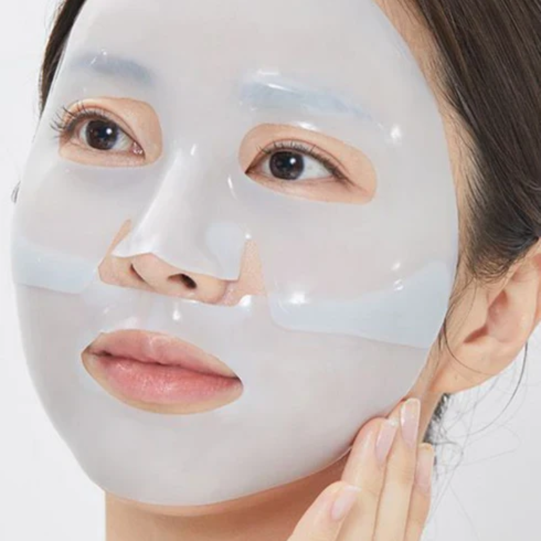 Person wearing a white face mask on a plain background