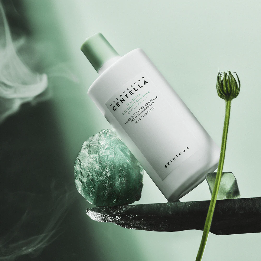 Skincoa Centella Asiatica skincare product with a flower and sponge on a green background
