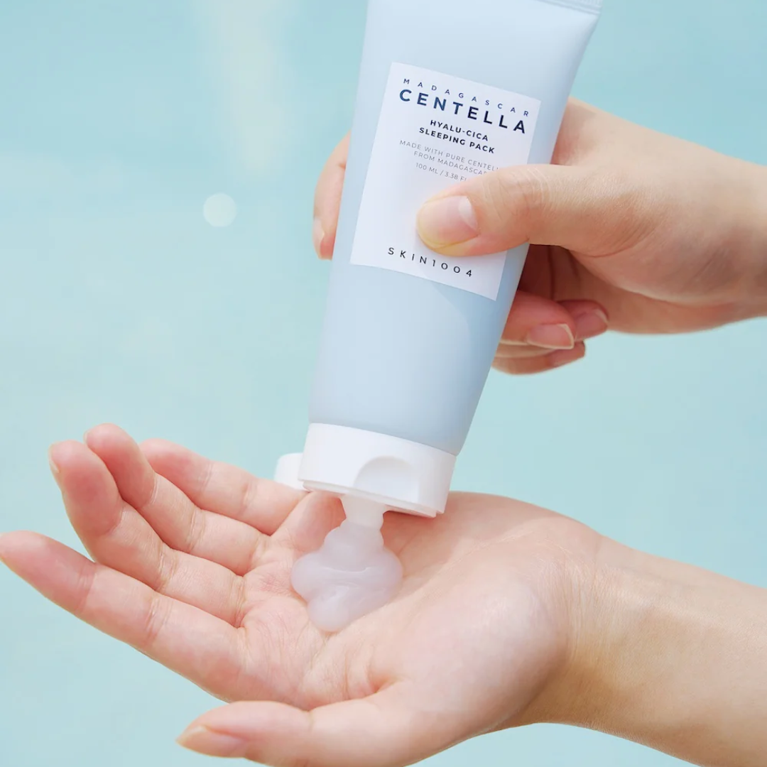 Hand holding a Skinfood Centella Hyaluronic Sleeping Pack against a light blue background