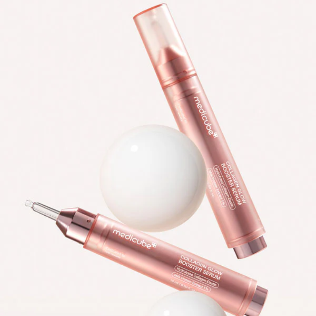 Two rose gold bottles of Medicube Lactic Glow Booster Serum on a white background