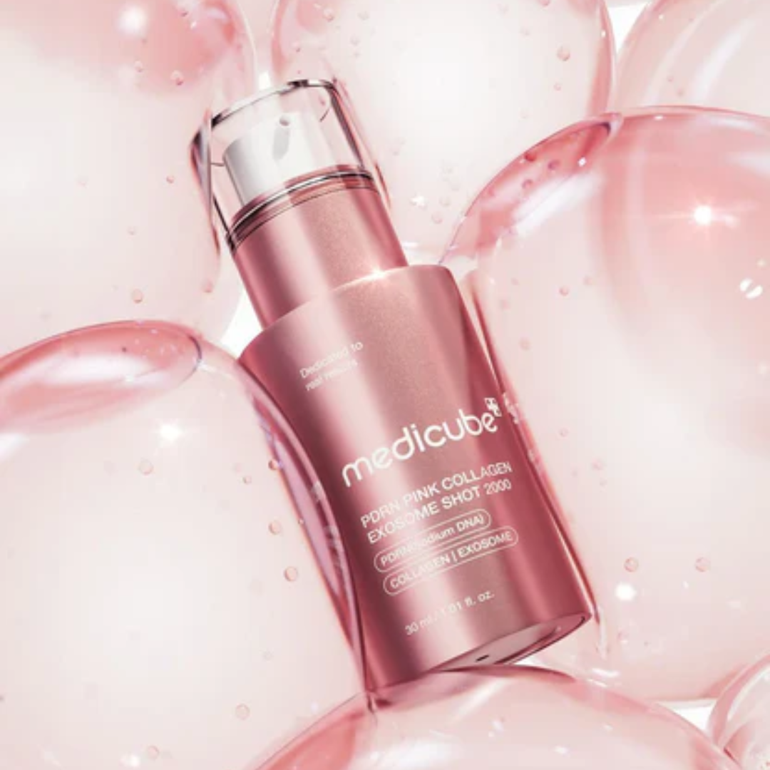 Pink skincare serum bottle with 'medicube' branding on a pink background