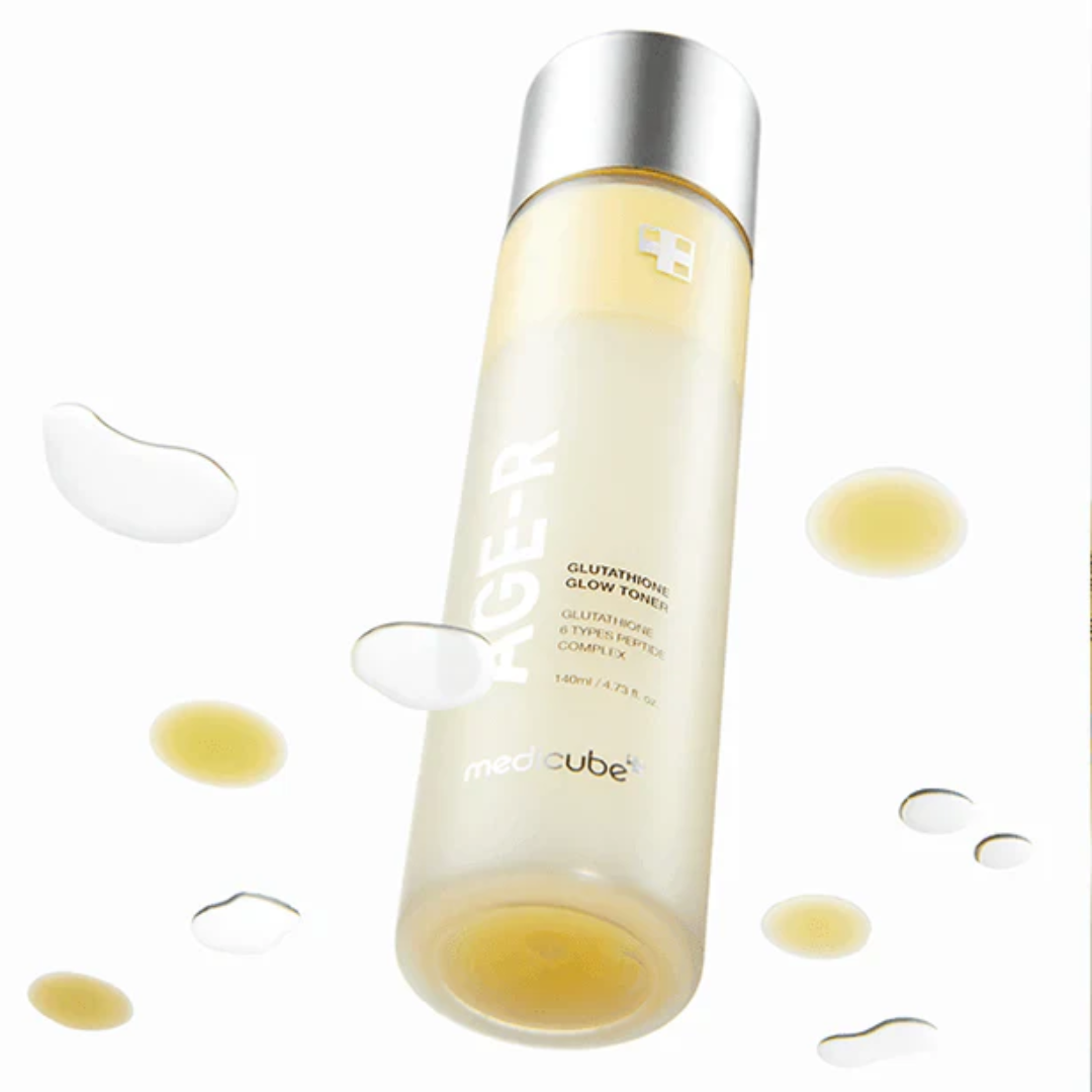 Skincare bottle with droplets and eye patches on a white background