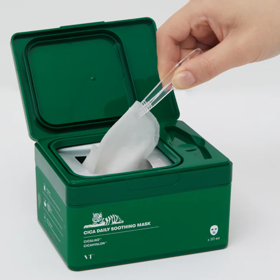 Green container with a white mask and a hand using a spoon to take out a mask.