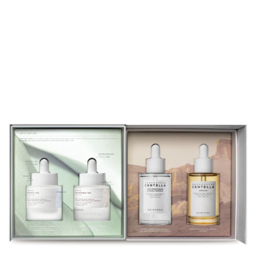 Set of skincare products in a box with droppers on a white background