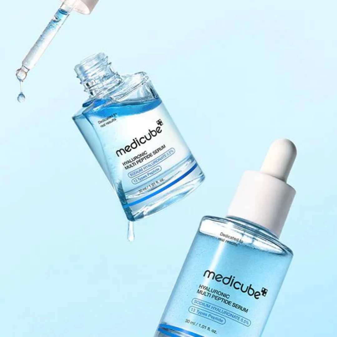 Two bottles of Medicube Hyaluronic Multi-Peptide Serum on a light blue background