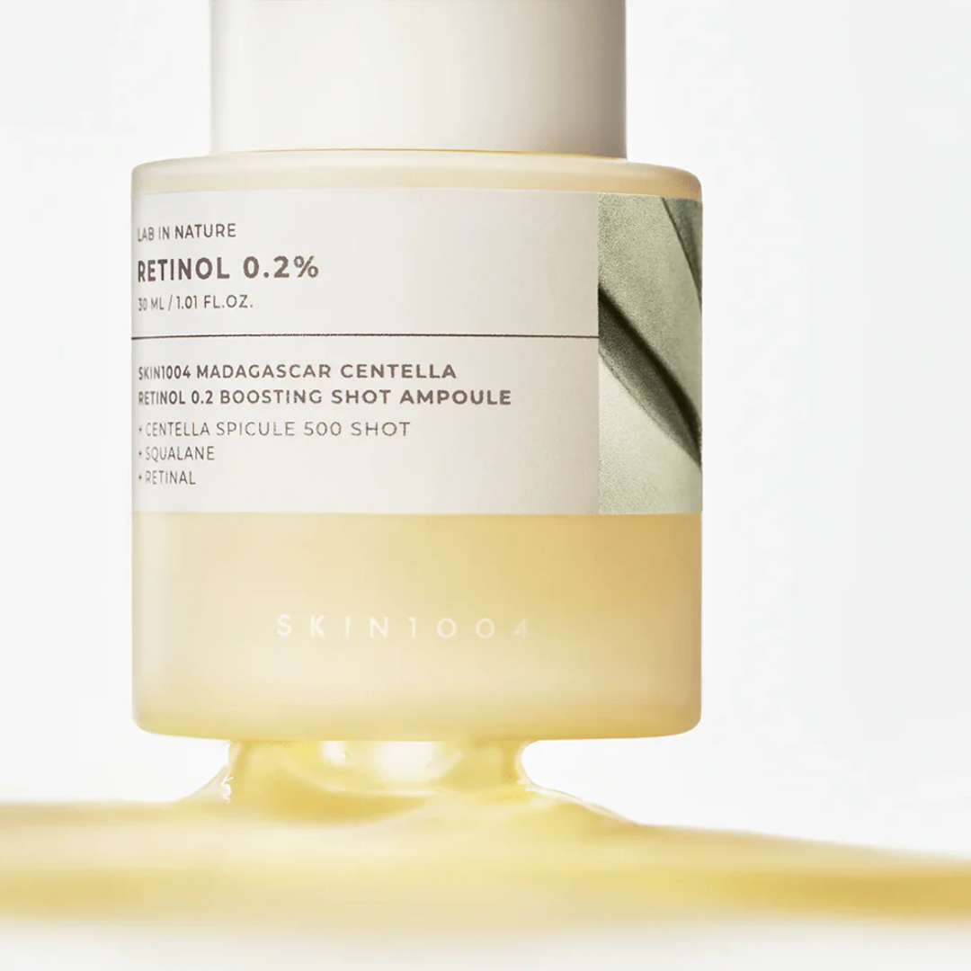 Skincare ampoule bottle with visible branding on a light background