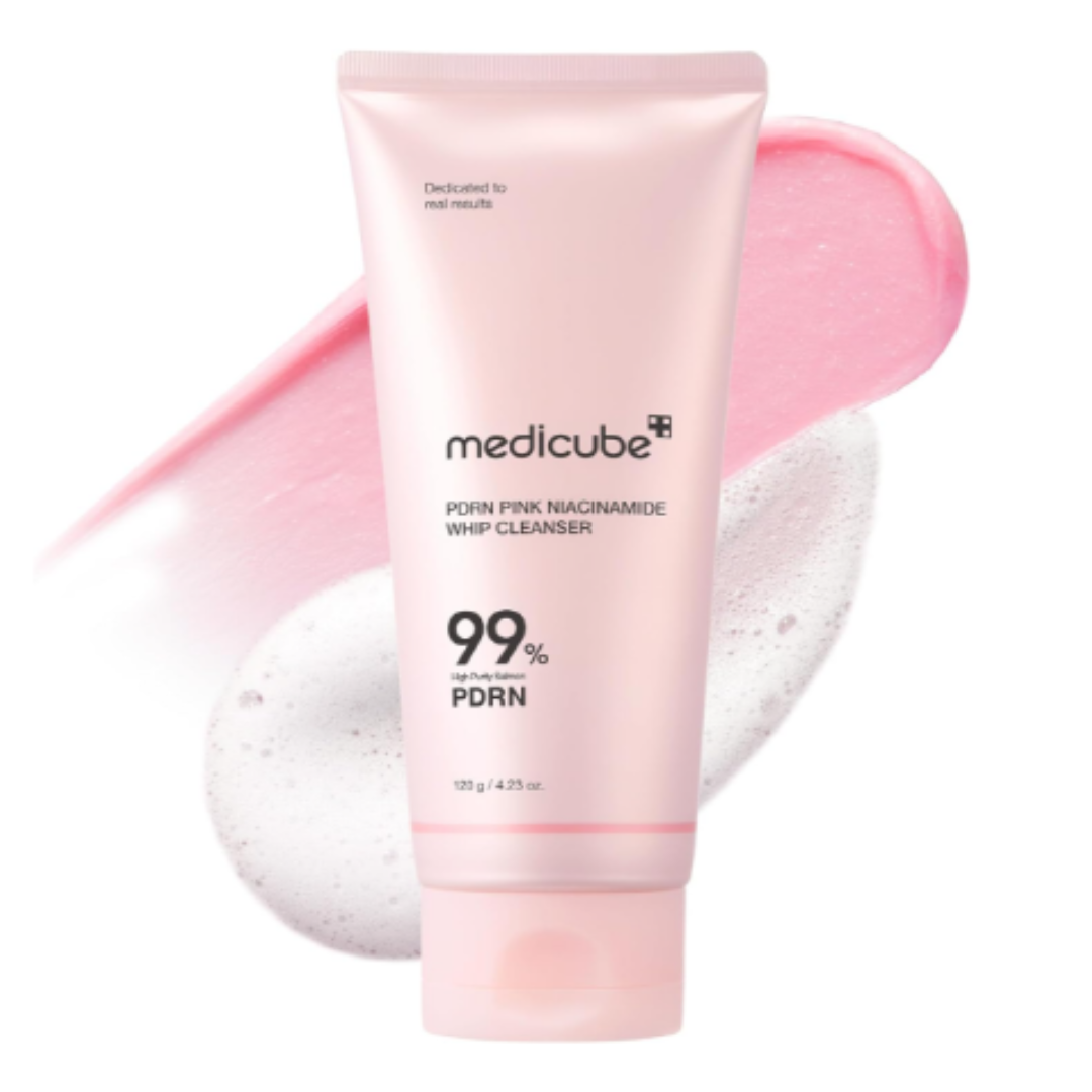 Pink tube of Medicube PDRN Pink Niacinamide Whip Cleanser with pink foam on a white background