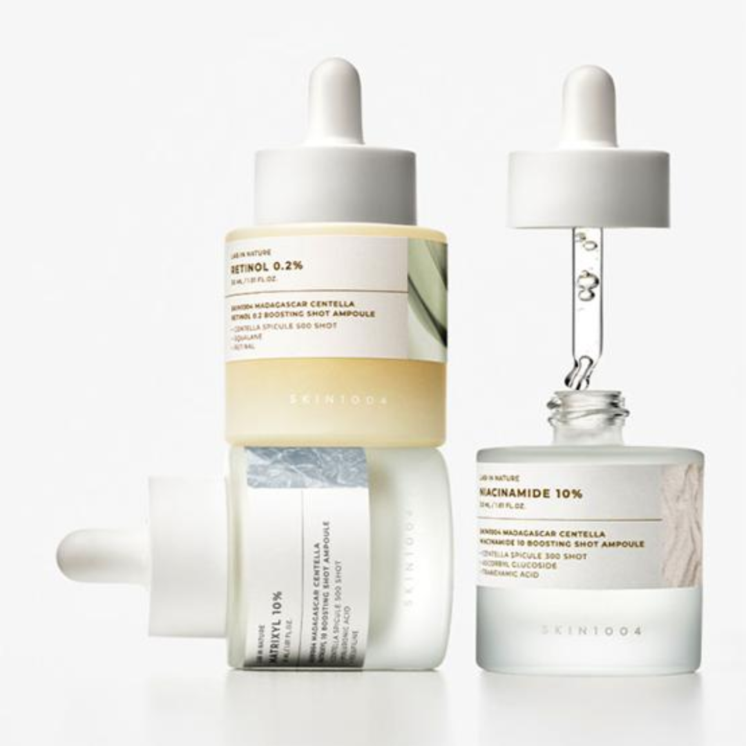 Two skincare ampoules with droppers on a white background