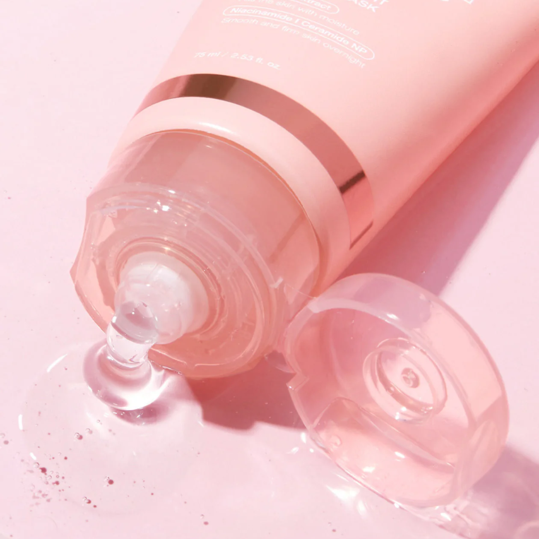 Pink skincare bottle with pump on a pink background