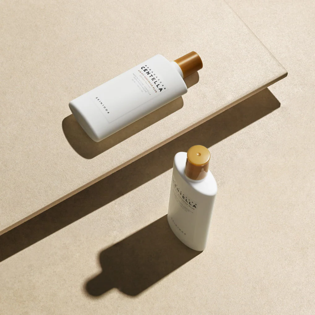Two bottles of Cantu hair care products on a beige surface with soft shadows.