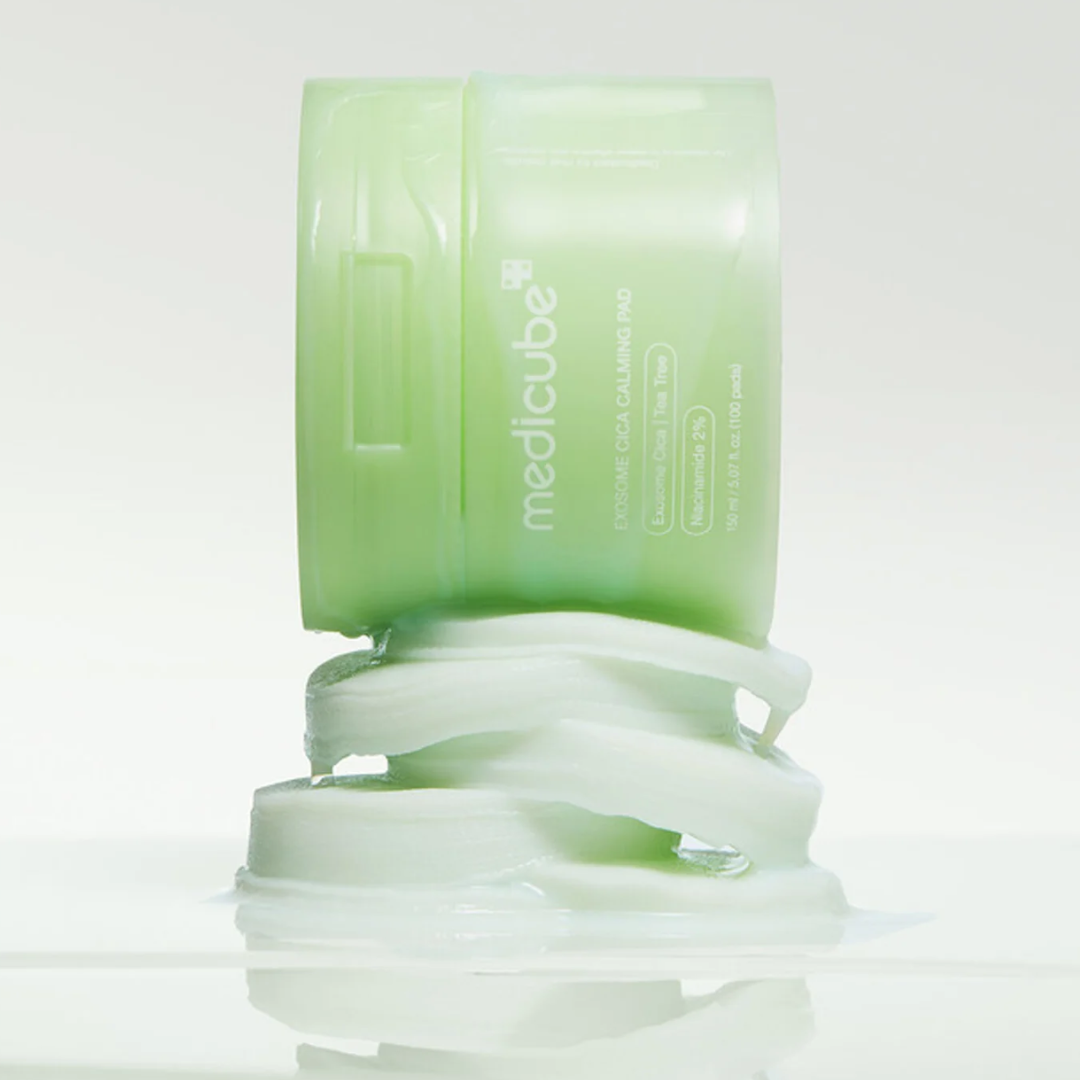 Green skincare product on pads on a light gray background