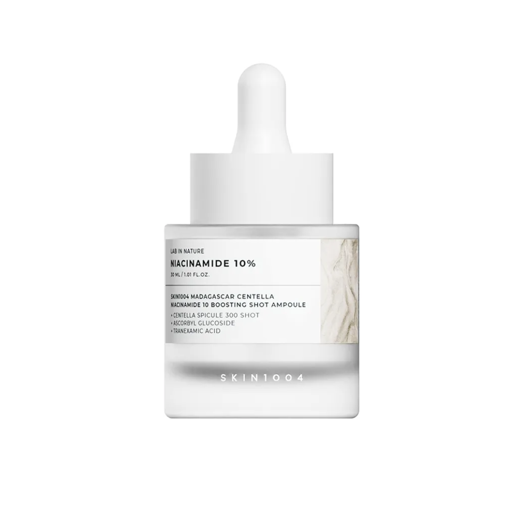Skincare product with dropper and marble design on a white background