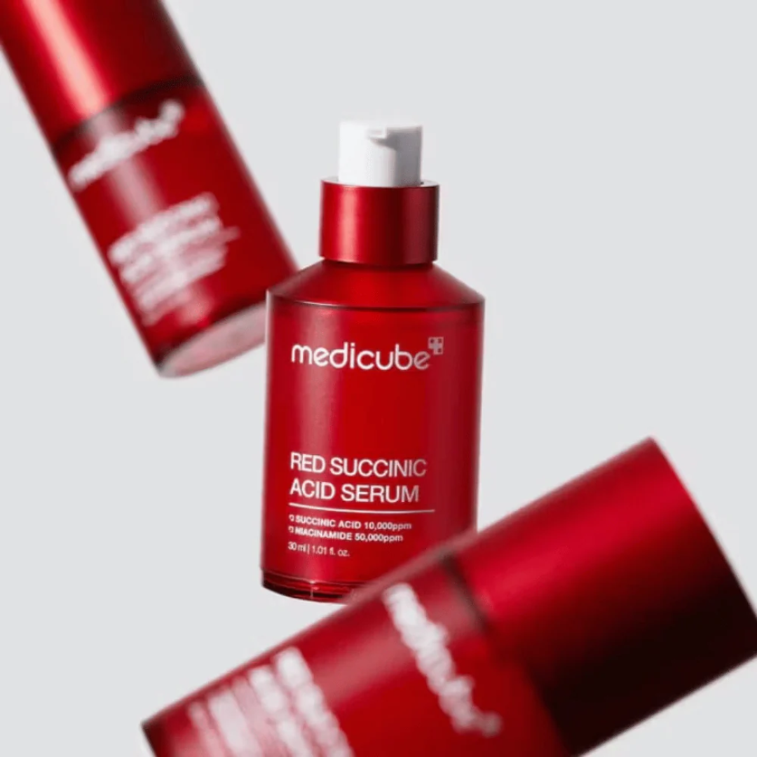 Medicube Red Silicone Serum bottle with red silicone cap on a light gray background