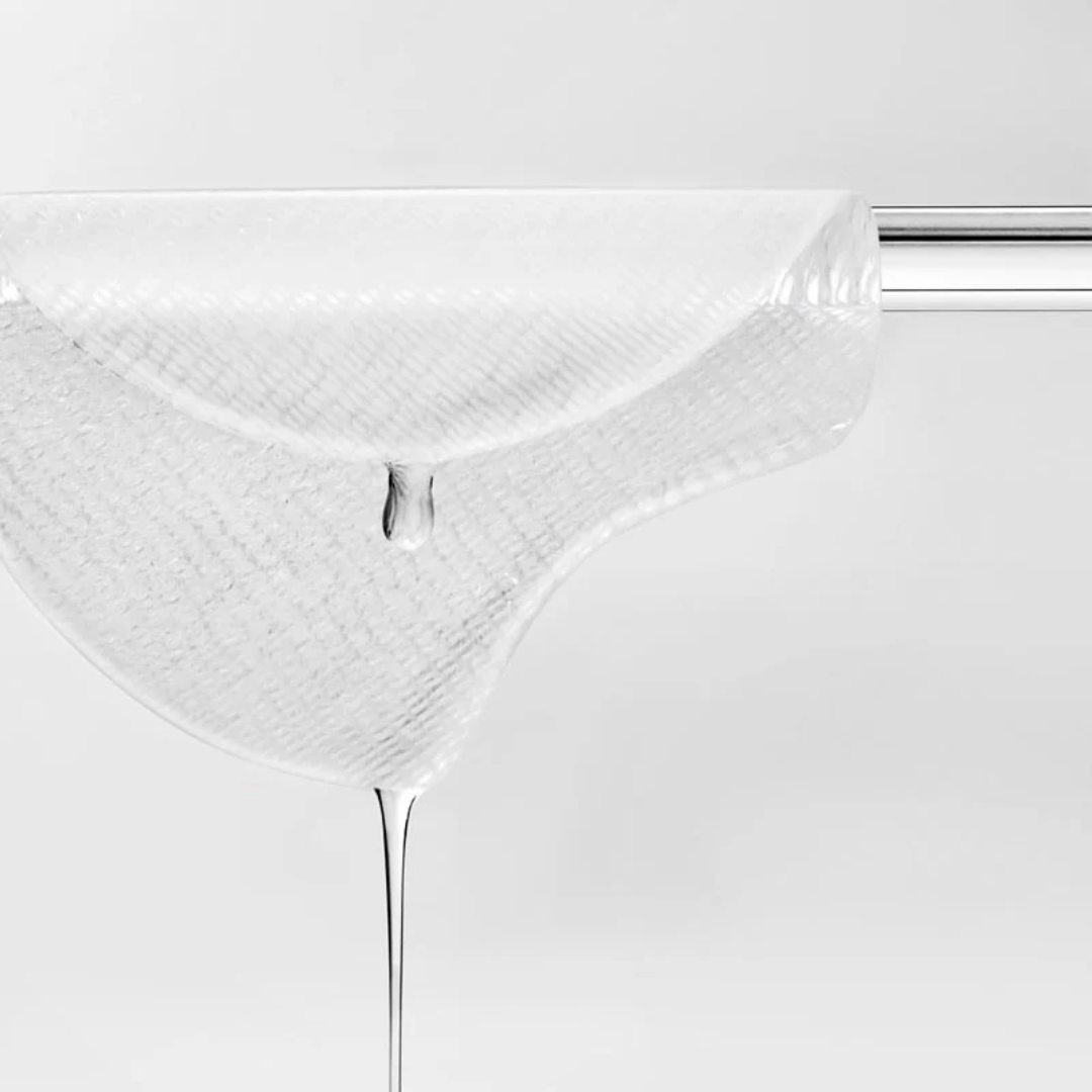 Close-up of a white pad with a small droplet on a white background